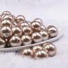 Front view of a pile of 16mm Light Champagne Gold Faux Pearl Acrylic Bubblegum Jewelry Beads