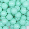 Close up view of a pile of 16mm Light Neon Blue Solid Acrylic Bubblegum Jewelry Beads