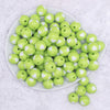 top view of a pile of 16mm Lime Green with White Hearts Bubblegum Beads