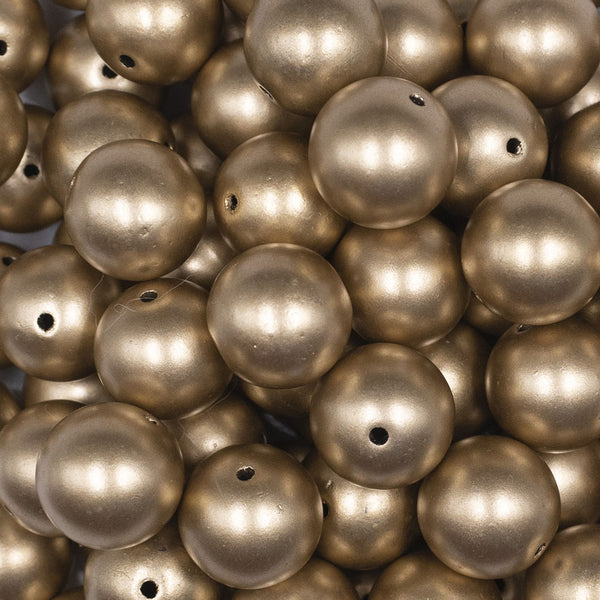 Close up view of a pile of 16mm Gold Matte Pearl Acrylic Bubblegum Jewelry Beads