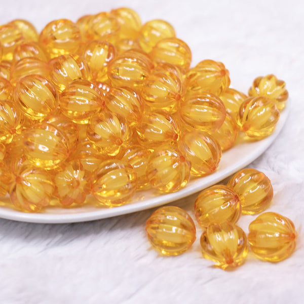 front view of a pile of 16mm Mustard Yellow Transparent Pumpkin Shaped Bubblegum Beads