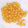 top view of a pile of 16mm Mustard Yellow Transparent Pumpkin Shaped Bubblegum Beads