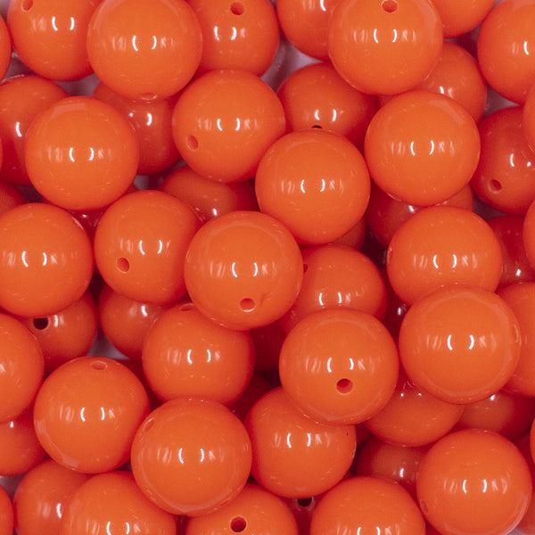 Close up view of a pile of  16mm Neon Orange Solid Acrylic Bubblegum Jewelry Beads