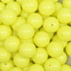 close up view of a pile of 16mm Neon Yellow Solid Acrylic Bubblegum Jewelry Beads