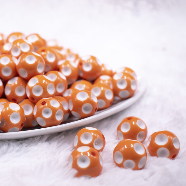front view of a pile of 16mm Orange with White Polka Dots Bubblegum Beads