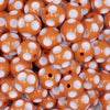 close up view of a pile of 16mm Orange with White Polka Dots Bubblegum Beads
