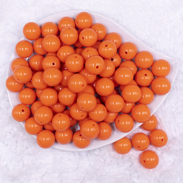 Top view of a pile of 16mm Orange Solid Acrylic Bubblegum Jewelry Beads