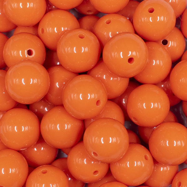 Close up view of a pile of 16mm Orange Solid Acrylic Bubblegum Jewelry Beads