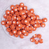 top view of a pile of 16mm Orange with White Stars Bubblegum Beads