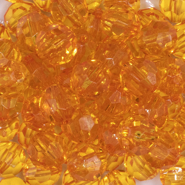 close up view of a pile of 16mm Orange Transparent Faceted Bubblegum Beads
