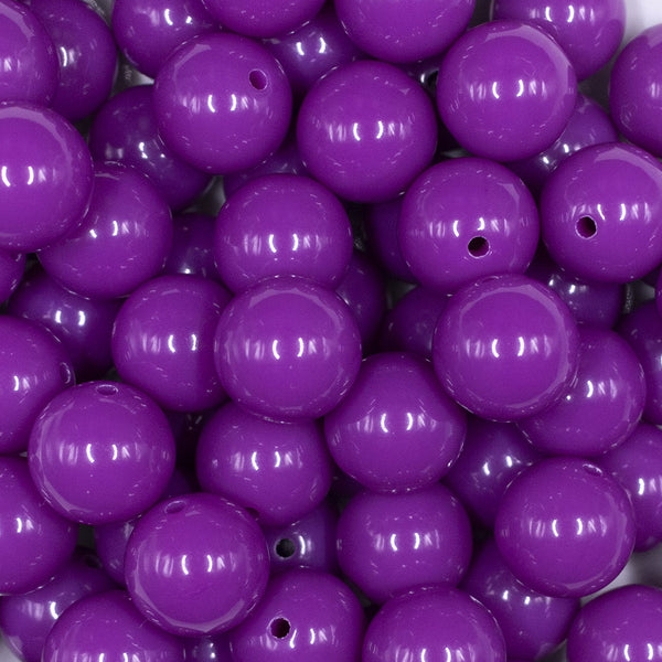 Close up view of a pile of 16mm Orchid Purple Solid Acrylic Bubblegum Jewelry Beads