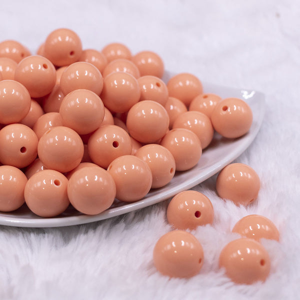 Front view of a pile of 16mm Peach Solid Acrylic Bubblegum Jewelry Beads