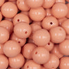 Close up view of a pile of 16mm Peach Solid Acrylic Bubblegum Jewelry Beads