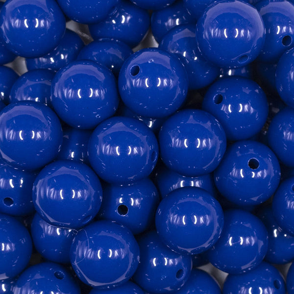 Close up view of a pile of 16mm Indigo Blue Solid Acrylic Bubblegum Jewelry Beads