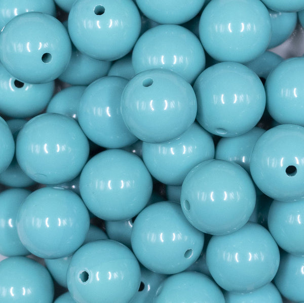 Close up view of a pile of 16mm Turquoise Blue Solid Acrylic Bubblegum Jewelry Beads