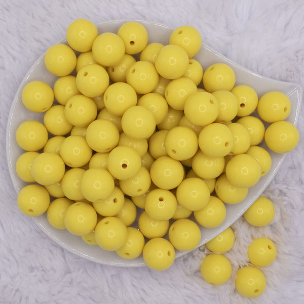 top view of a pile of 12mm Yellow Solid Acrylic Bubblegum Beads