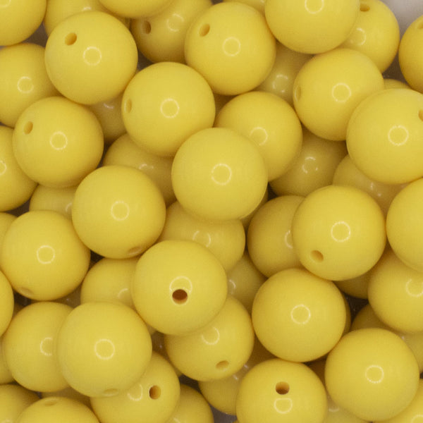 close up view of a pile of 12mm Yellow Solid Acrylic Bubblegum Beads