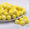 front view of a pile of 16mm Yellow with White Hearts Bubblegum Beads