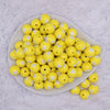 top view of a pile of 16mm Yellow with White Hearts Bubblegum Beads