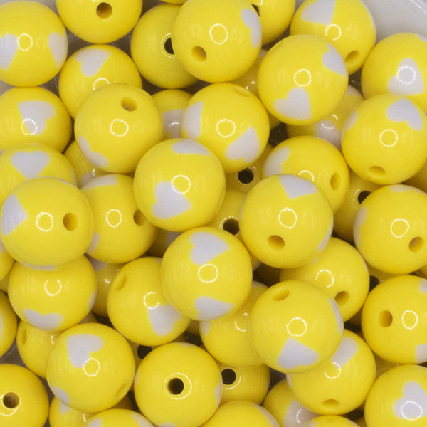 close up view of a pile of 16mm Yellow with White Hearts Bubblegum Beads