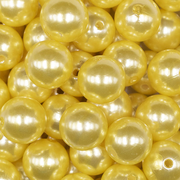 Close up view of a pile of 16mm Yellow Faux Pearl Acrylic Bubblegum Jewelry Beads