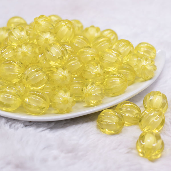 front view of a pile of 16mm Yellow Transparent Pumpkin Shaped Bubblegum Beads