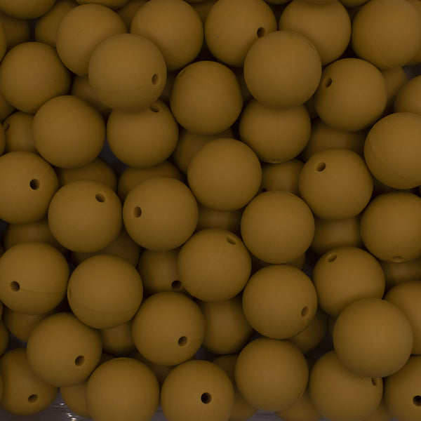close up view of a pile of 19mm Mustard Yellow Round Silicone Bead