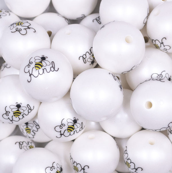 Close up view of a pile of 20mm Bee Kind print on Matte White Chunky Acrylic Bubblegum Beads jewelry