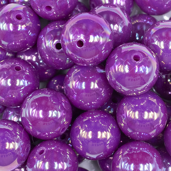 Close up view of a pile of 20MM Dark Purple Neon AB Solid Chunky Bubblegum Beads