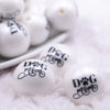 Macro view of a pile of 20mm Dog Mom print on Matte White Chunky Acrylic Bubblegum Beads jewelry