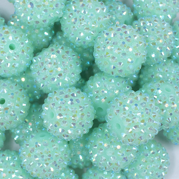 Close up view of a pile of 20mm Neon Light Blue Rhinestone AB Bubblegum Beads