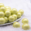 front view of a pile of 20mm Lime Green Matte Pearl Solid Jewelry Acrylic Bubblegum Beads