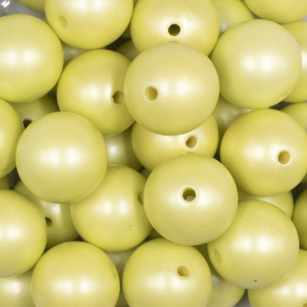 Close up view of a pile of 20mm Lime Green Matte Pearl Solid Jewelry Acrylic Bubblegum Beads