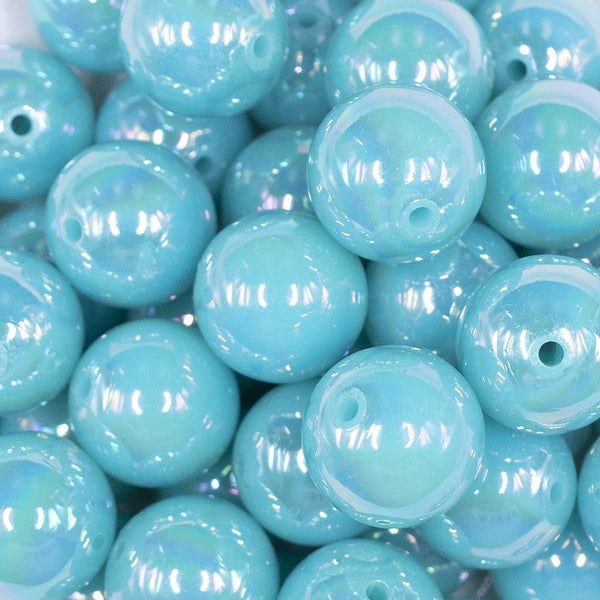 Close up view of a pile of 20MM Medium Blue Neon AB Solid Chunky Bubblegum Beads