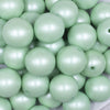Close up view of a pile of 20mm Mint Green Matte Pearl Solid Jewelry Acrylic Bubblegum Beads