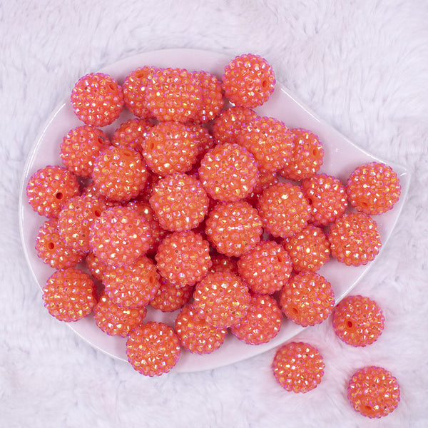 Top view of a pile of 20mm Neon Orange Rhinestone AB Bubblegum Beads
