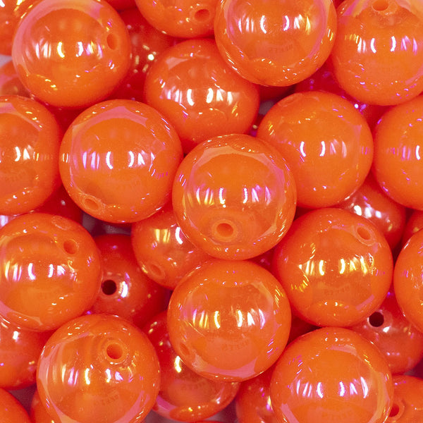 Close up view of a pile of 20MM Orange Neon AB Solid Chunky Bubblegum Beads
