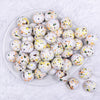 top view of a pile of 20mm Orange, Yellow & Black Splatter on White Chunky Acrylic Bubblegum Beads