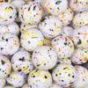 close up view of a pile of 20mm Orange, Yellow & Black Splatter on White Chunky Acrylic Bubblegum Beads