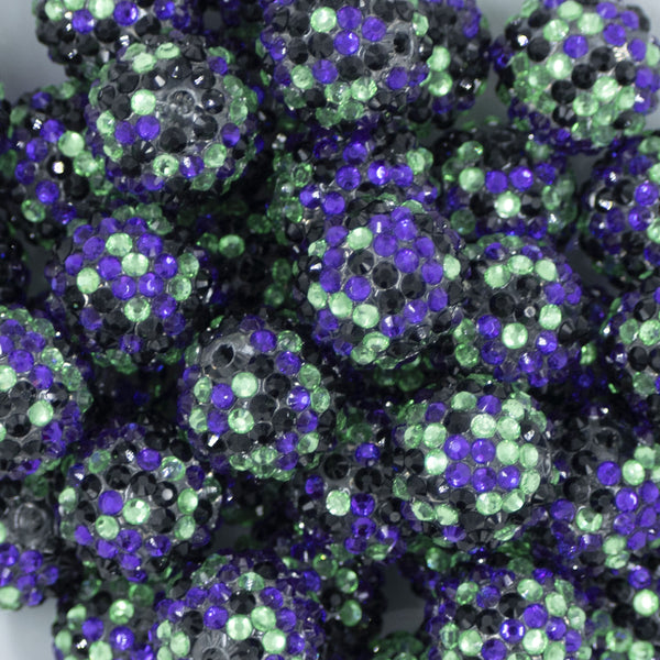 Close up view of a pile of 20mm Purple, Green & Black Confetti Rhinestone AB Bubblegum Beads