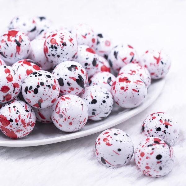 front view of a pile of 20mm Black & Red Splatter on White Chunky Acrylic Bubblegum Beads