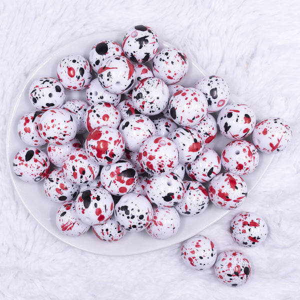 top view of a pile of 20mm Black & Red Splatter on White Chunky Acrylic Bubblegum Beads
