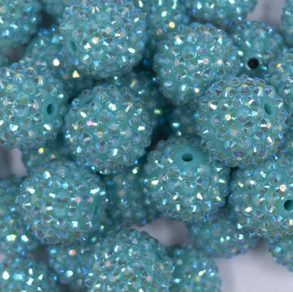 Close up view of a pile of 20mm Teal Rhinestone AB Bubblegum Beads