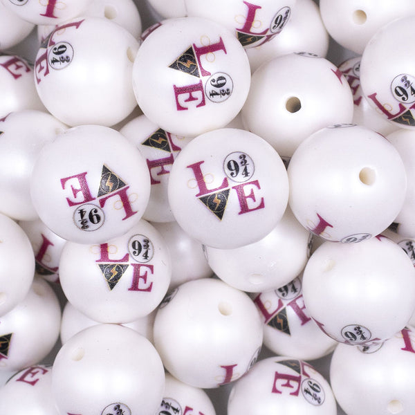 Close up view of a pile of 20mm Wizardly Love print on Matte White Chunky Acrylic Bubblegum Beads jewelry