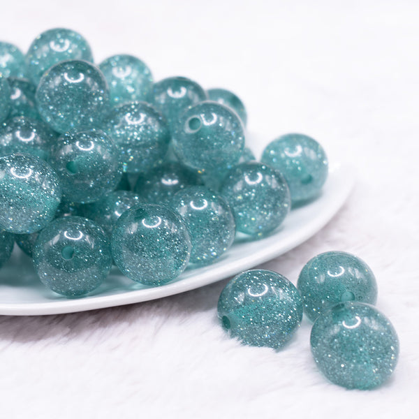 front view of a pile of 20mm Aqua Blue Glitter Sparkle Bubblegum Beads