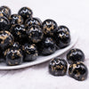 front view of a pile of 20mm Black and Gold Flake Resin Chunky Bubblegum Beads