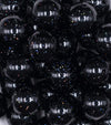 Close up view of a pile of 20mm Black with Glitter Faux Pearl Bubblegum Beads