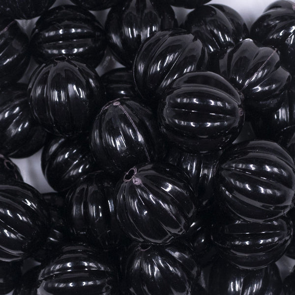 Close up view of a pile of 20mm Black Opaque Pumpkin Shaped Bubblegum Bead
