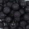 Close up view of a pile of 20mm Black Stardust Chunky Bubblegum Beads