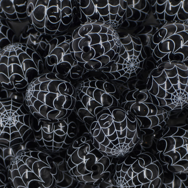 Close up view of a pile of 20mm Black & White Spider Web Print Bubblegum Beads